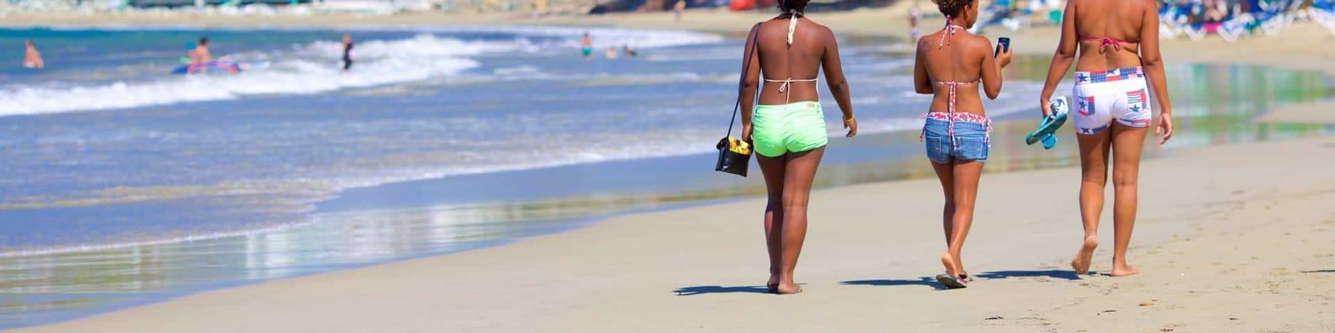 Puerto Plata showing a beach as well as a small group of people