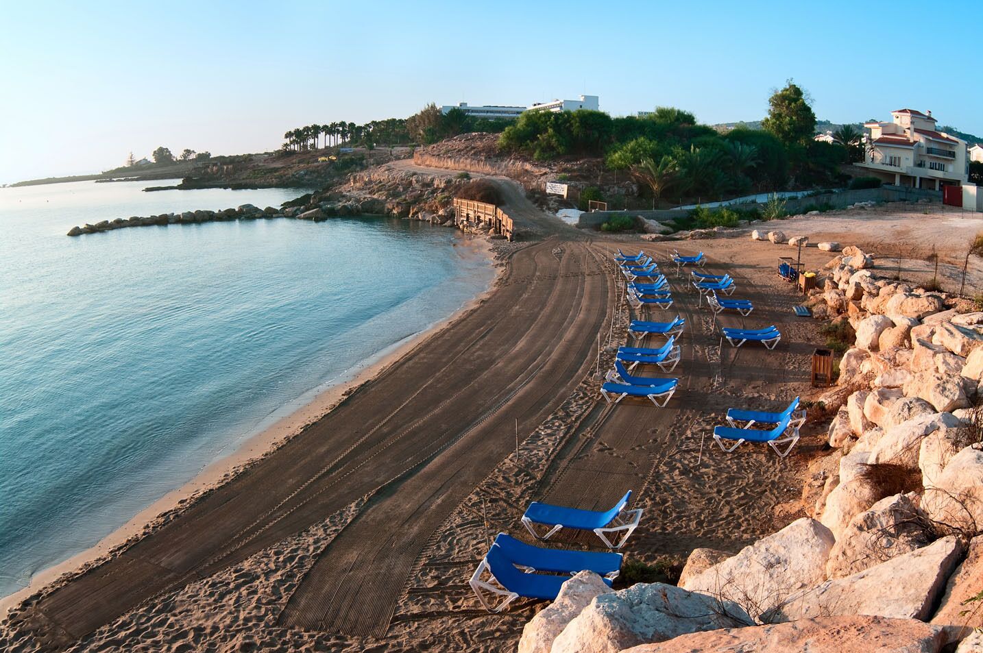 Mediterranean sea and municipal beach in Protaras, Cyprus, Europe. Early morning and clear sunbeds on sand
