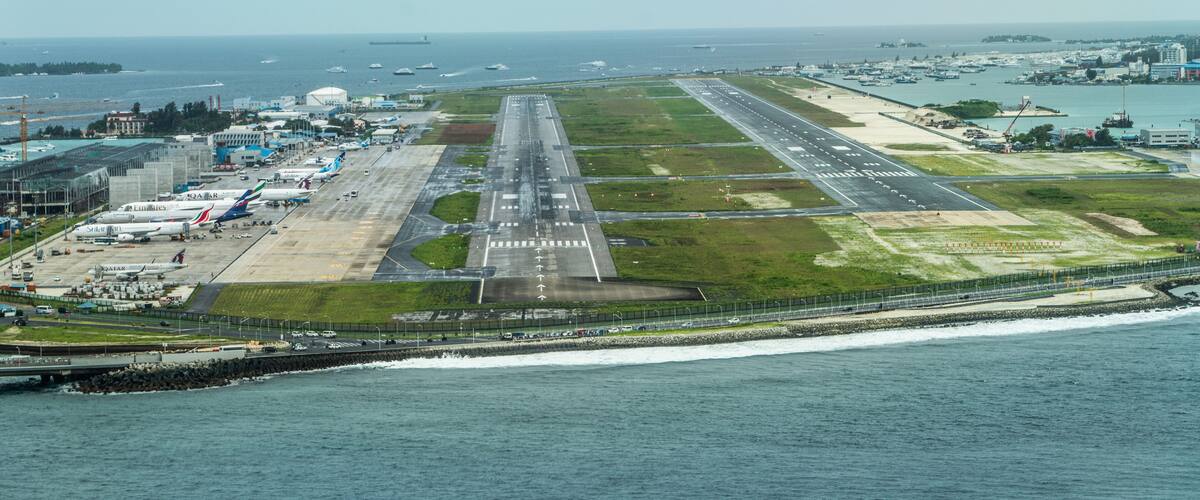 An airport with multiple runways and aircraft parked on the tarmac.