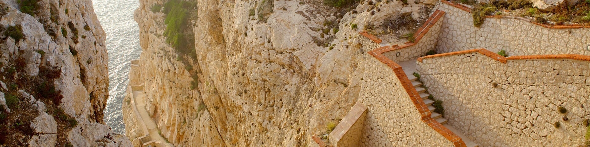 Capo Caccia featuring a gorge or canyon and rugged coastline