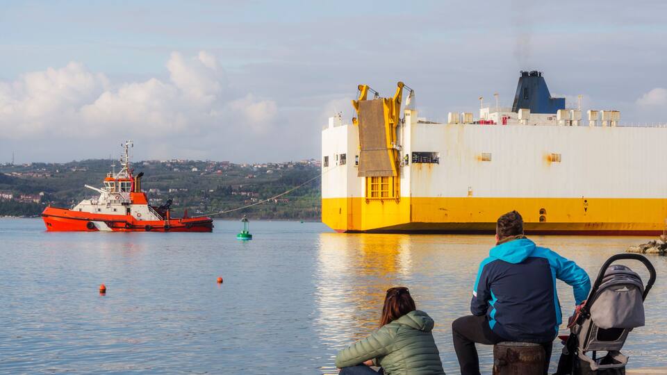 Container ship with tug boat at the port of Koper in Slovenia