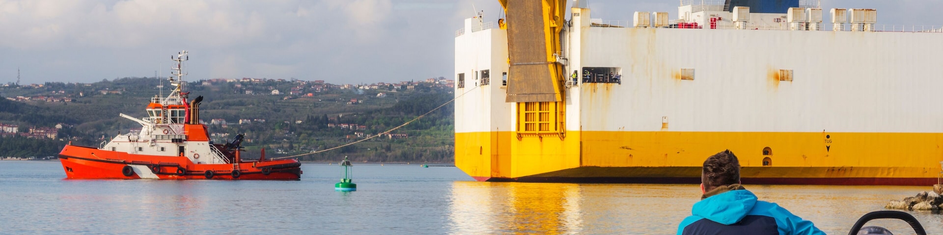 Container ship with tug boat at the port of Koper in Slovenia
