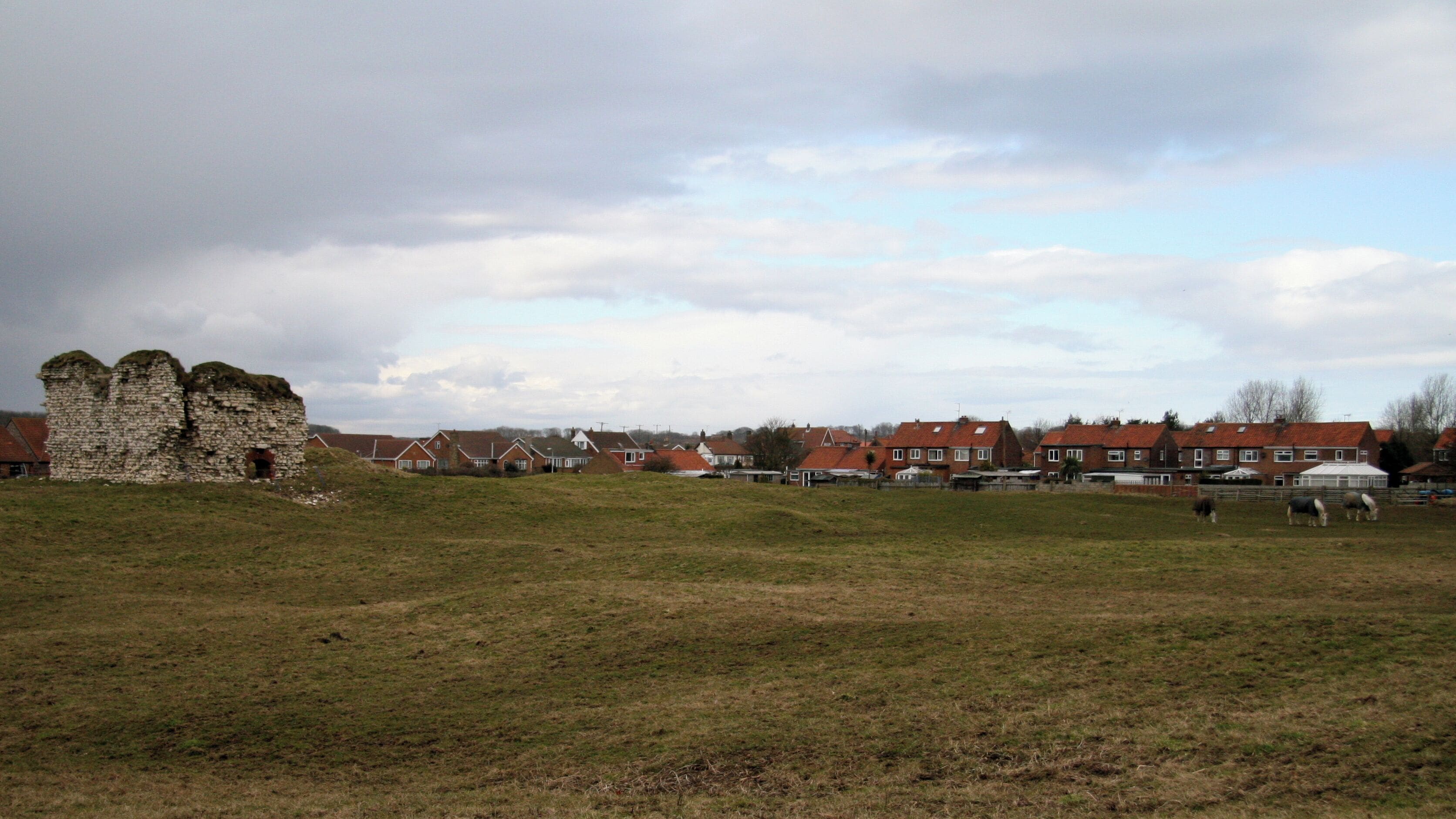 Flamborough Castle, Flamborough, East Riding of Yorkshire, England. The photograph shows the tower, being the only remains above ground, and associated earthworks. This 'castle' was, in fact, the fortified manor house of the Constable family who had received licence to crenelate in 1351. Although containing a tower, a hall, a great parlour, a lord's parlour, a chapel, a court house, a mill house, and a great barn it was described in the early 16th century as being taken for a manor house rather than a castle. It can be compared with the Northumbrian 'Pele' towers and, like them, was probably made defensible to guard against Scottish raiders. The above paragraph was adapted from an East Riding Council leaflet that is available online: http://www.eastriding.gov.uk/EasySiteWeb/GatewayLink.aspx?alId=2256 . Click here for another photograph of the castle: https://www.geograph.org.uk/photo/1772032 . For a photograph showing the tower, click here: https://www.geograph.org.uk/photo/1772013 . - - - For other photographs of the castle see the following by: Paul Allison: 1862, Paul Glazzard: 835908 and J Thomas: 1212589.