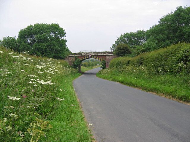 Bridge near Bempton, East Riding of Yorkshire, England. Looking north to the rail bridge over the road into Bempton in the adjacent grid square north. It looks like this square is mostly farmland.