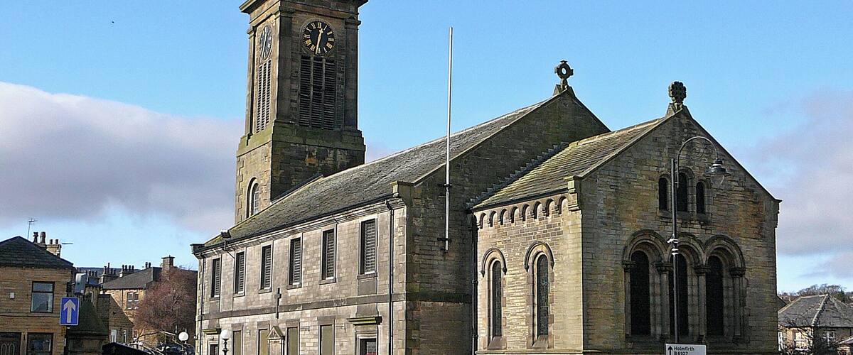 A historic church with a clock tower and a smaller adjacent building.