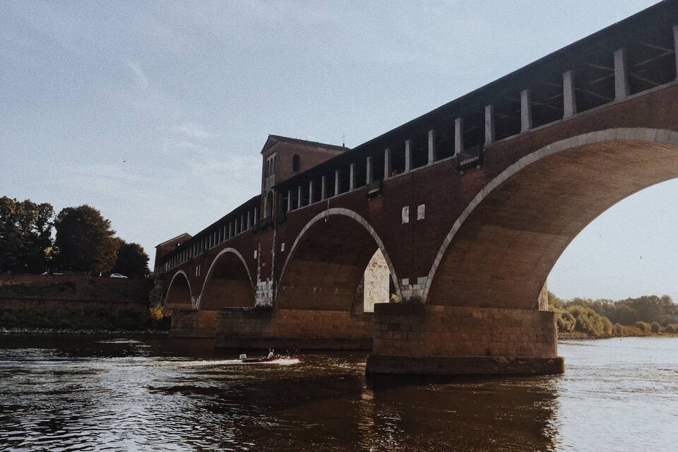 A stone bridge with multiple arches spanning a river.