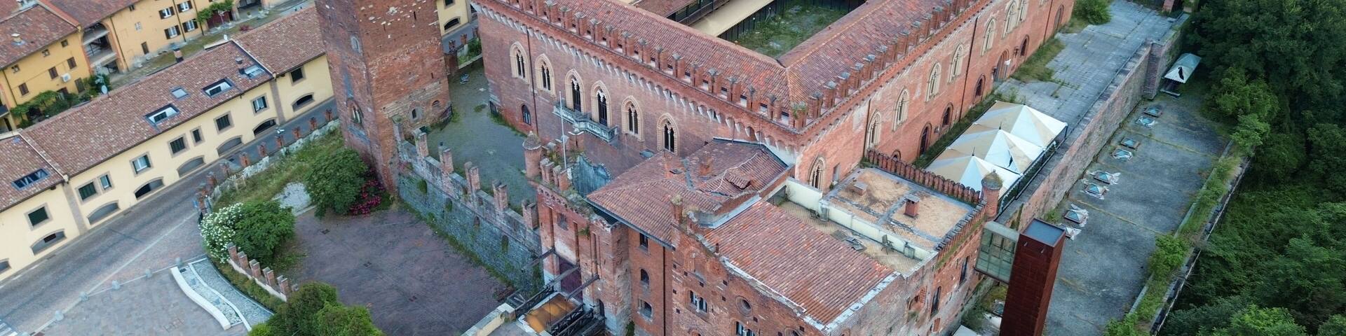 aerial view about Carimate Castle surrounded by green wild forest in sunrise lights