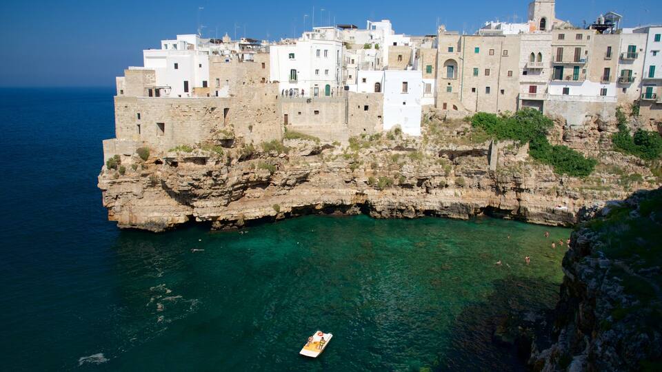 A coastal town with buildings built on a rocky cliff overlooking the sea.