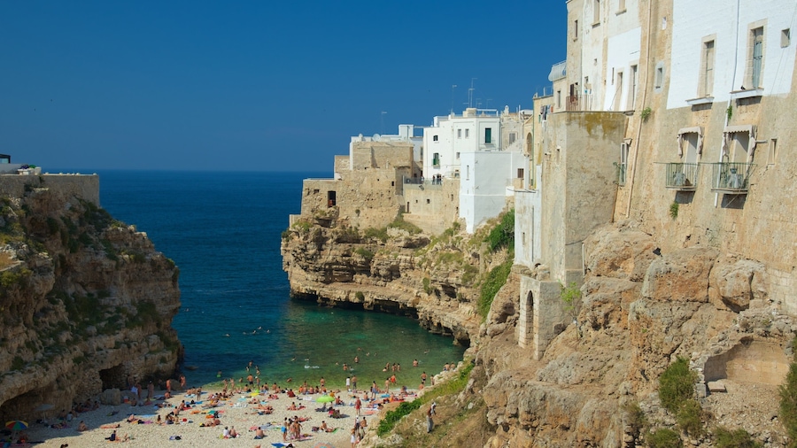 Polignano a Mare featuring a coastal town, a pebble beach and rocky coastline