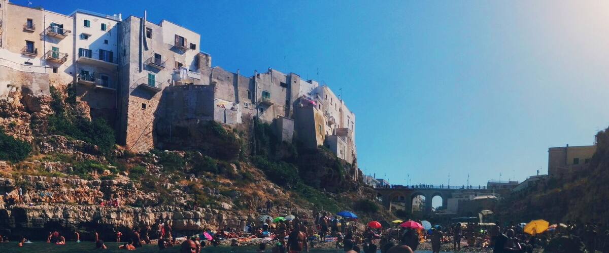 Polignano a Mare is a city close to Bari. This specific beach is peculiar for its location underneath the city centre. As a consequence, you can see people and houses from the water and they can see you from there! #colorful