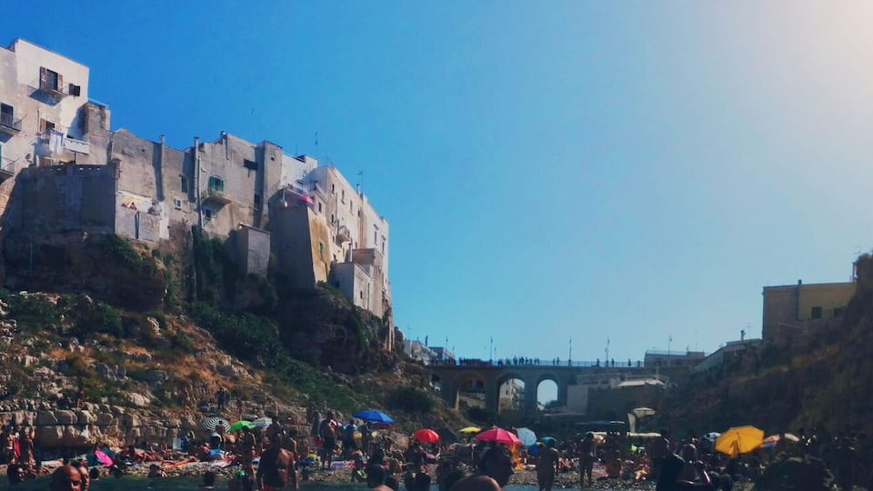 Polignano a Mare is a city close to Bari. This specific beach is peculiar for its location underneath the city centre. As a consequence, you can see people and houses from the water and they can see you from there! #colorful