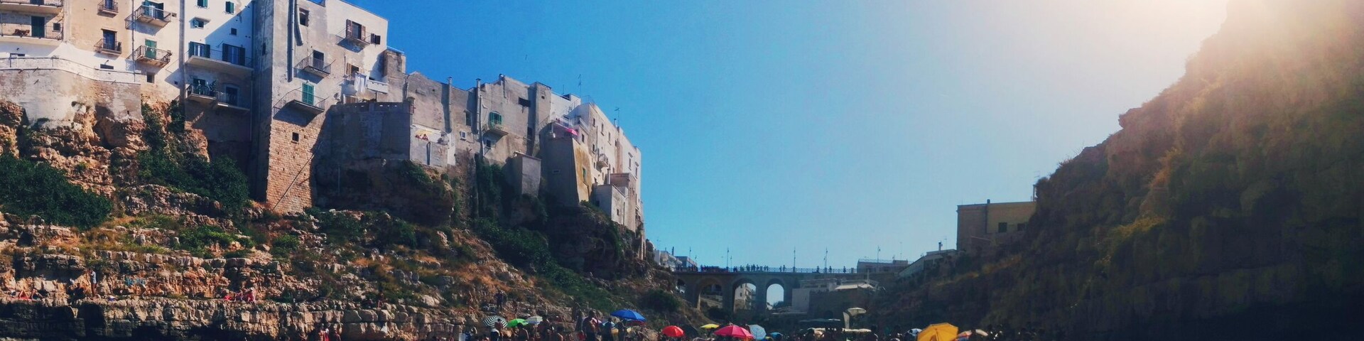 Polignano a Mare is a city close to Bari. This specific beach is peculiar for its location underneath the city centre. As a consequence, you can see people and houses from the water and they can see you from there! #colorful