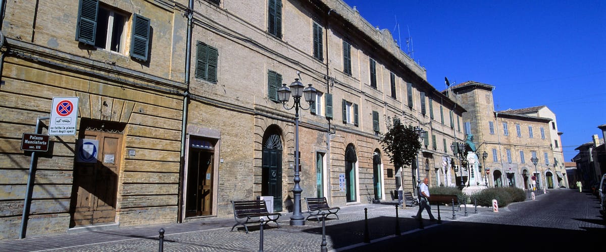 A historic building with arched windows and a cobblestone street.
