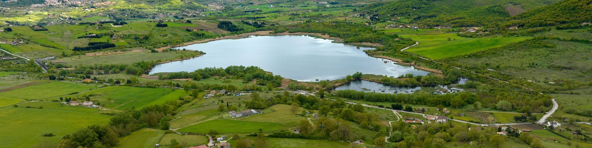 Aerial view of Pantano lake, near Pignola, in the province of Potenza, Italy. On the horizon there is the small town.