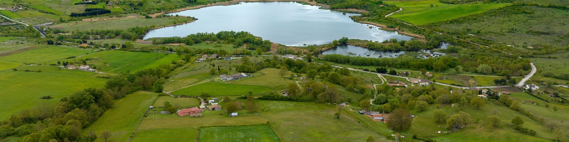 Aerial view of Pantano lake, near Pignola, in the province of Potenza, Italy. On the horizon there is the small town.