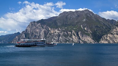 A boat on a calm sea with a mountainous backdrop.