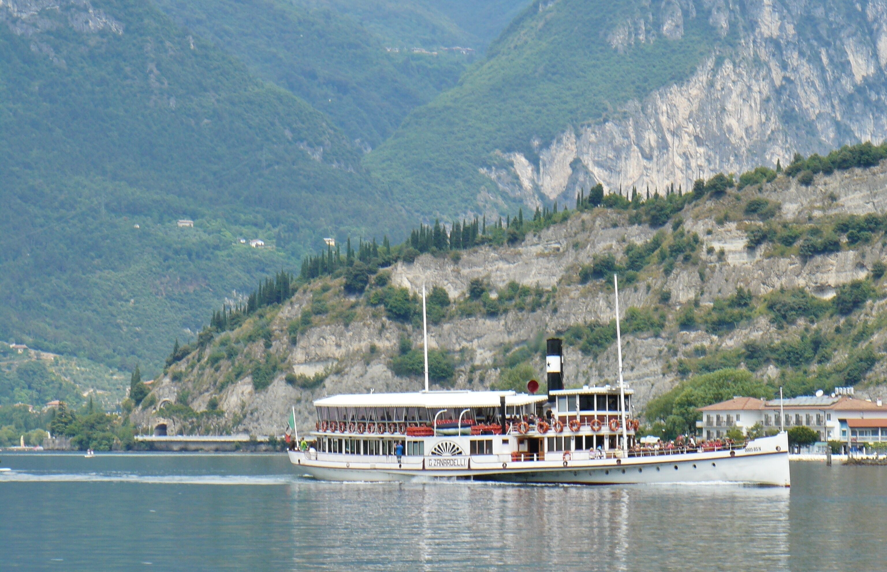 A boat on a lake with mountains in the background.