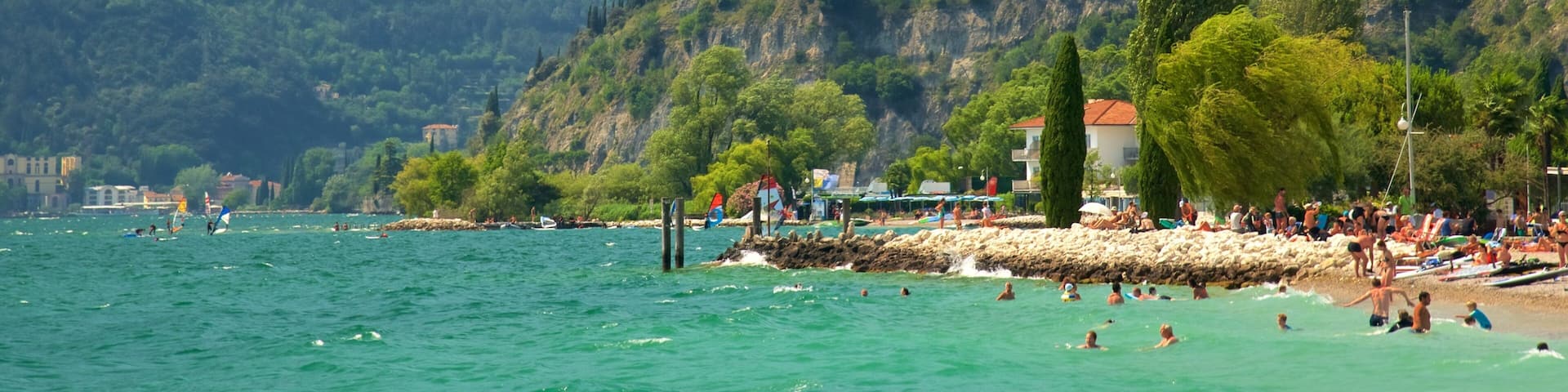 Nago-Torbole featuring a sandy beach, swimming and mountains