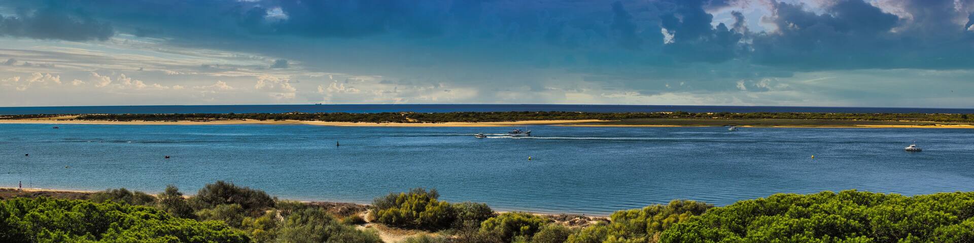 Panoramic of El Portil beach with sky clouds