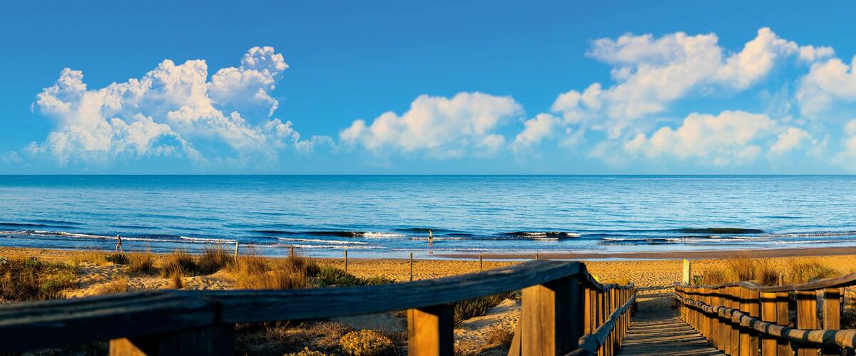 Panoramic of El Portil beach with sky clouds