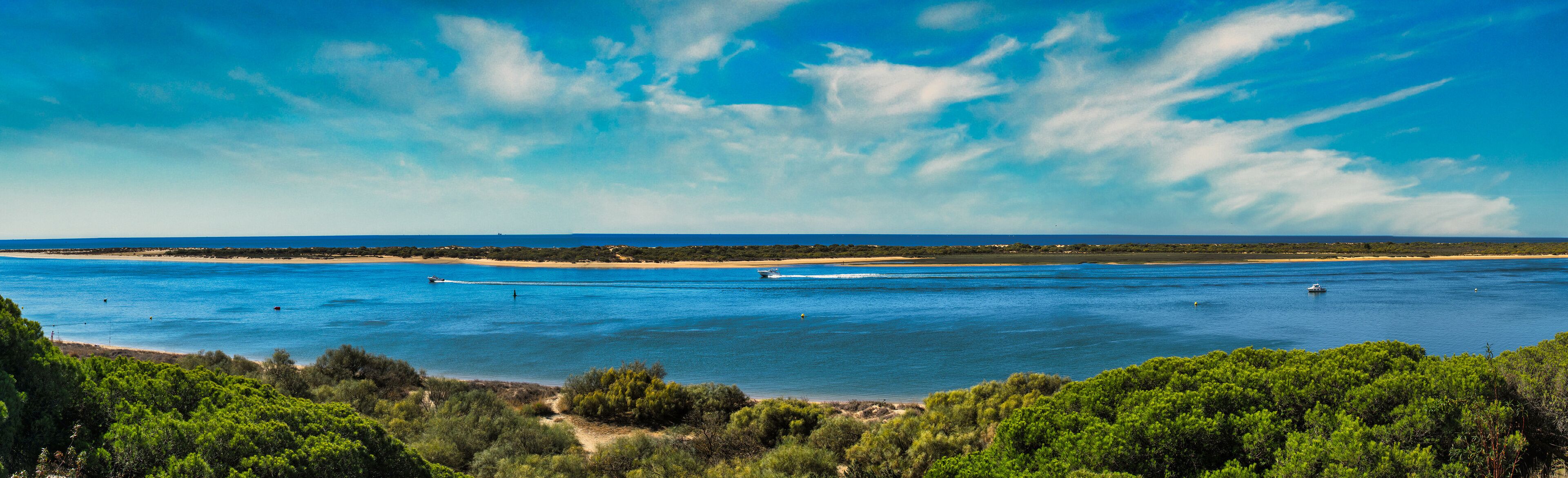 Panoramic of El Portil beach with sky clouds