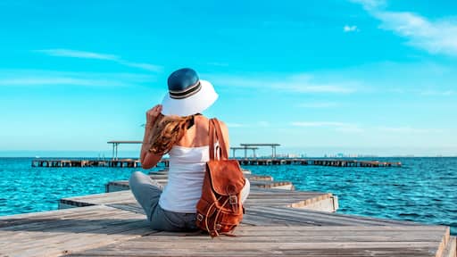 Panorama of Mar Menor lagoon, from Los Alcazares, Murcia, Spain- woman tourist sitting and enjoying panorama view