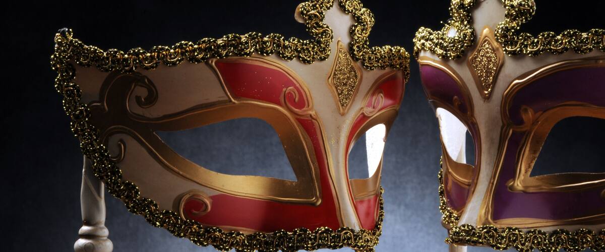 Two ornate masks with gold and red details.