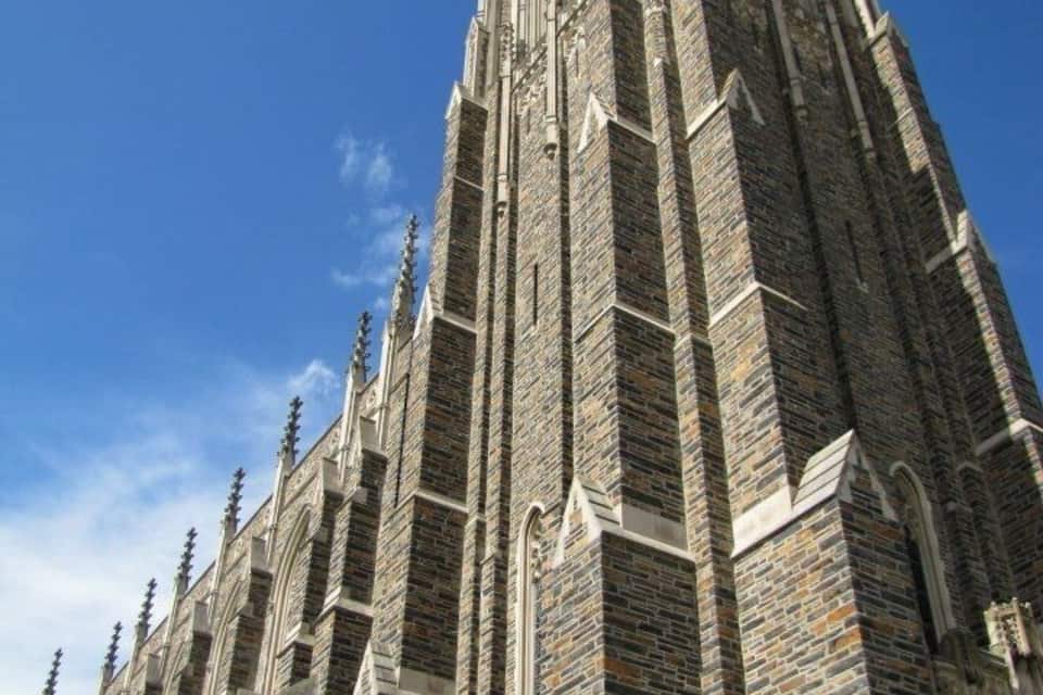 A tall, Gothic-style church with intricate stonework and pointed arches.