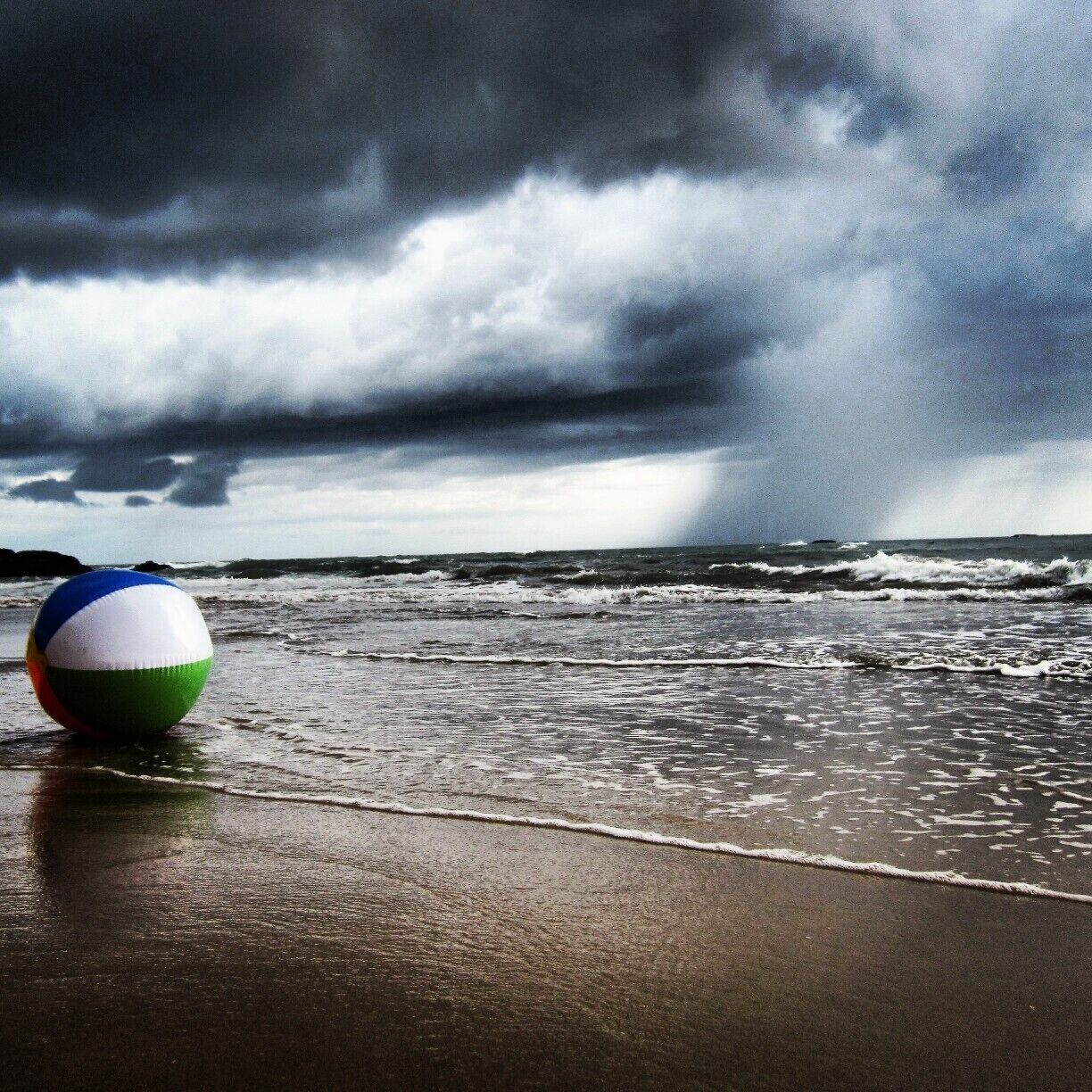 Beachball awaiting a storm moving on the shores of Playa Ventanas  Pura Vida!
