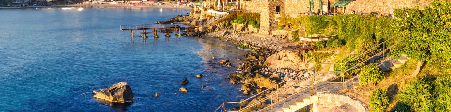 Coastal landscape banner, panorama - embankment with fortress wall in the city of Sozopol on the Black Sea coast in Bulgaria