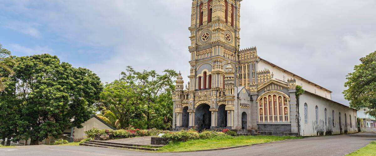 A large, ornate church with a tall bell tower and intricate architectural details.