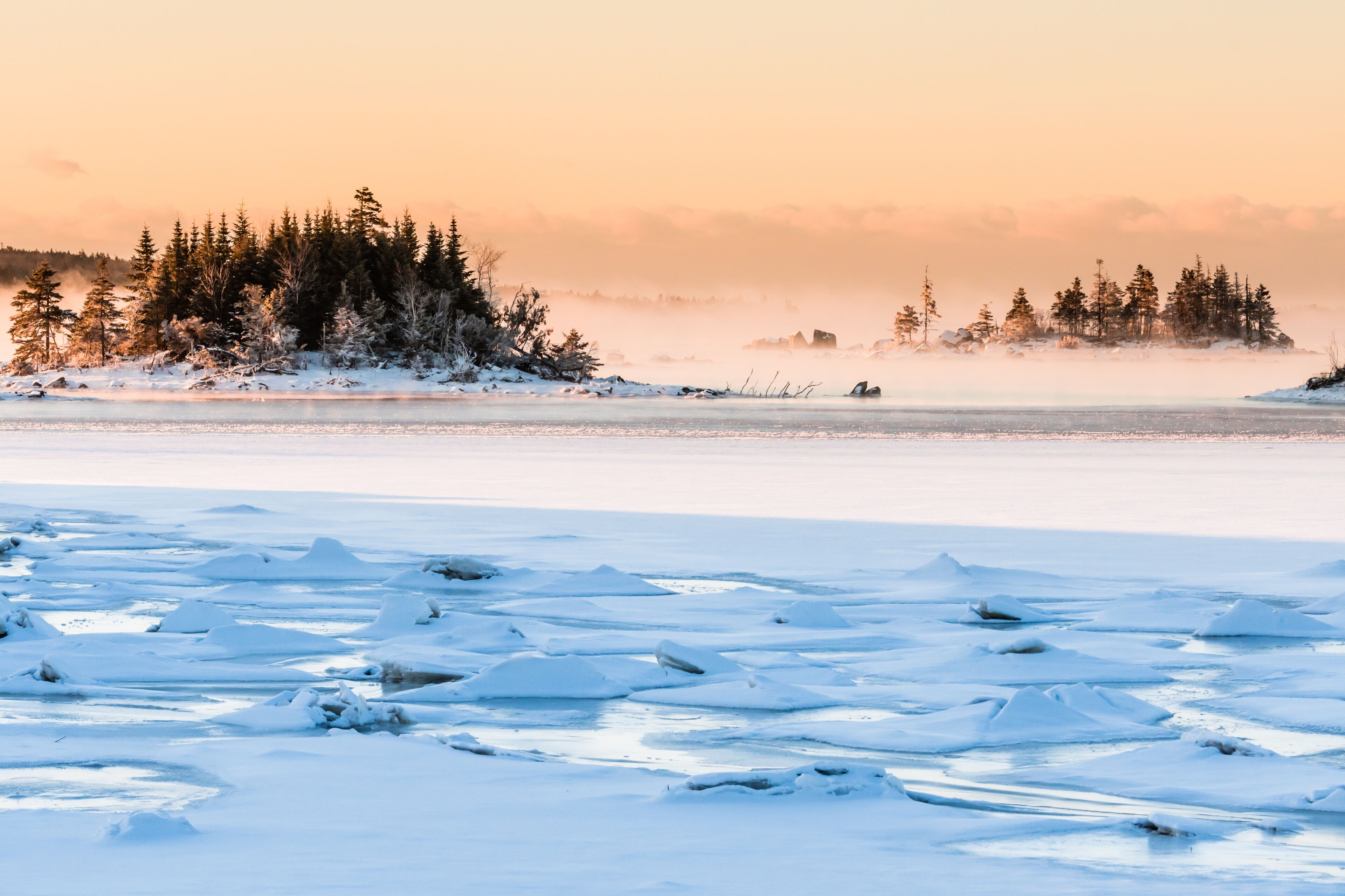 morning fog over frozen ocean bay