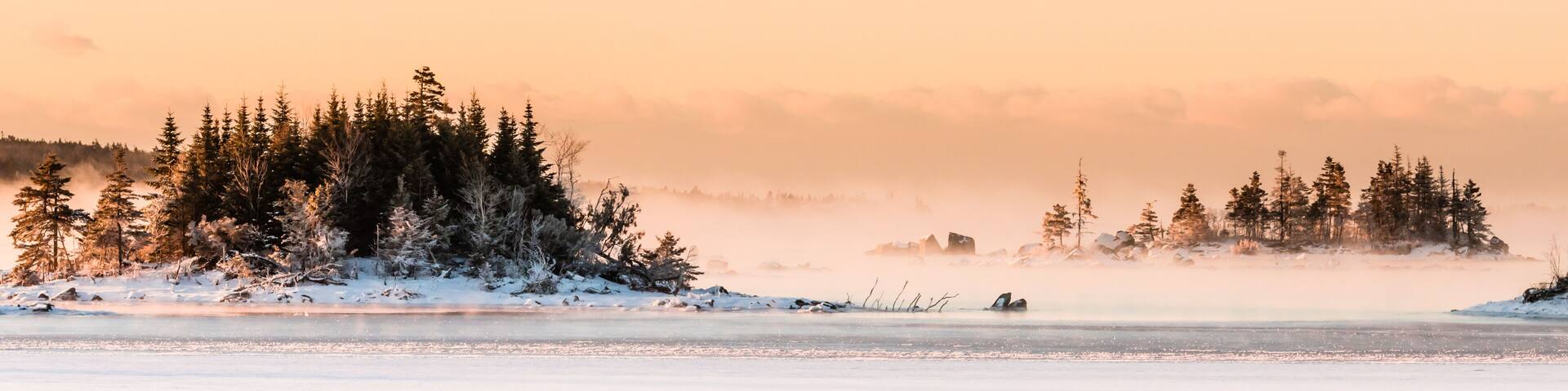 morning fog over frozen ocean bay