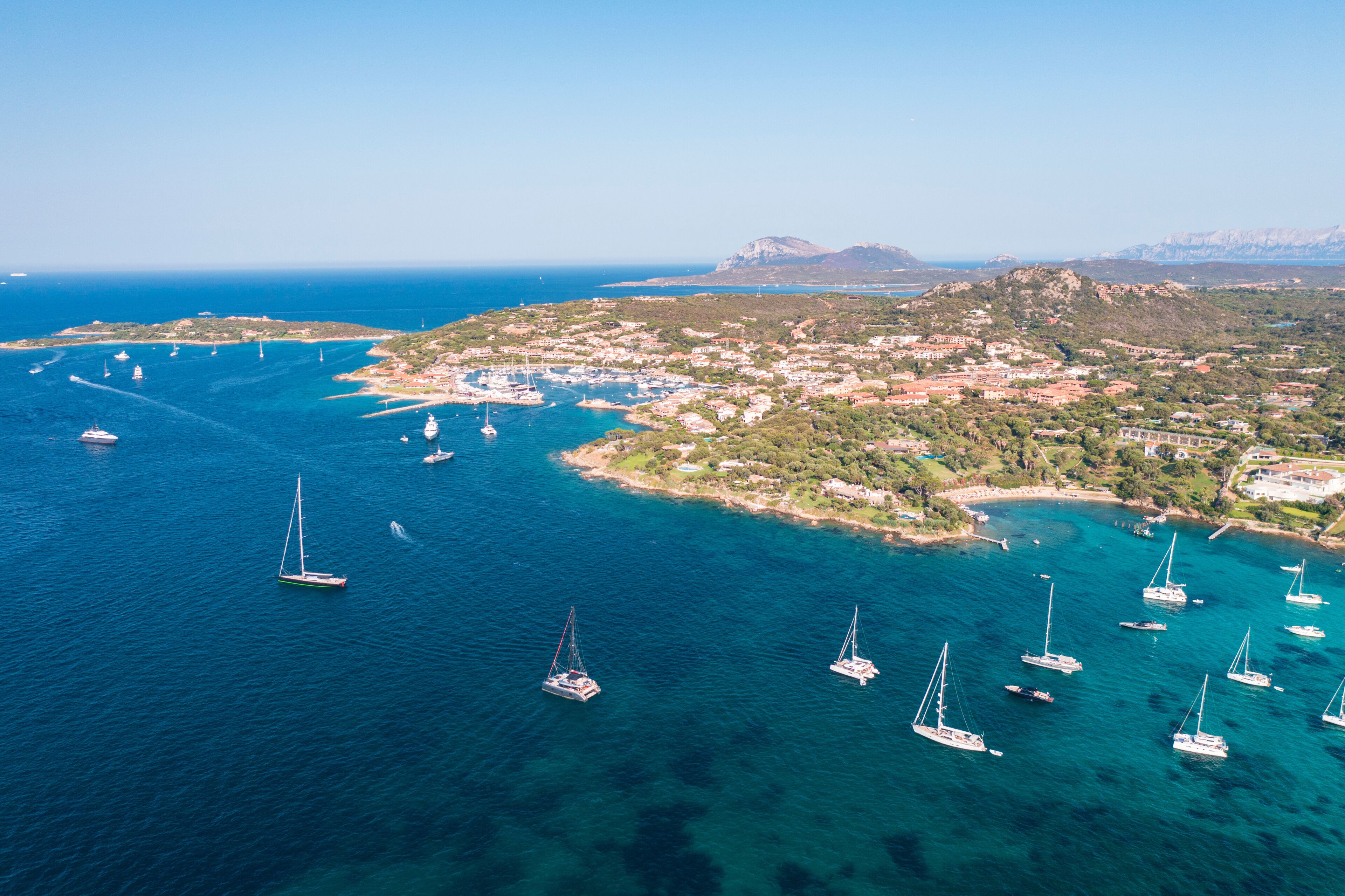 Aerial view of Porto Rotondo bay with sailboats and turquoise water, Olbia, Sardinia, Italy