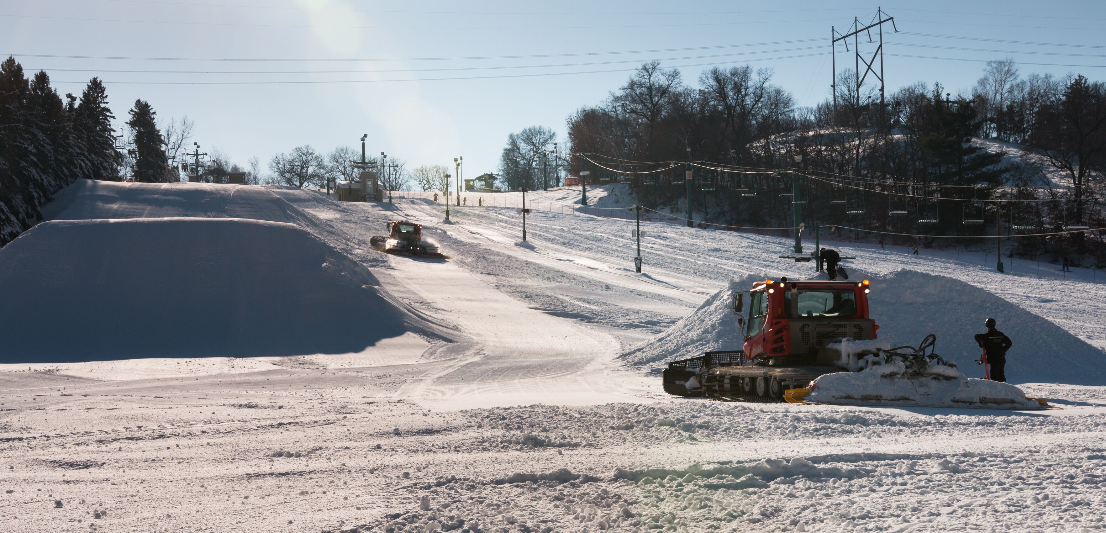 Workers build terrain park at  ski field, Afton Alps, Minnesota,