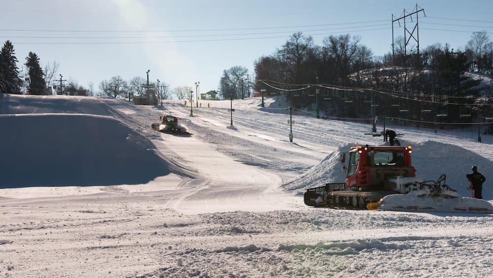 Workers build terrain park at ski field, Afton Alps, Minnesota,