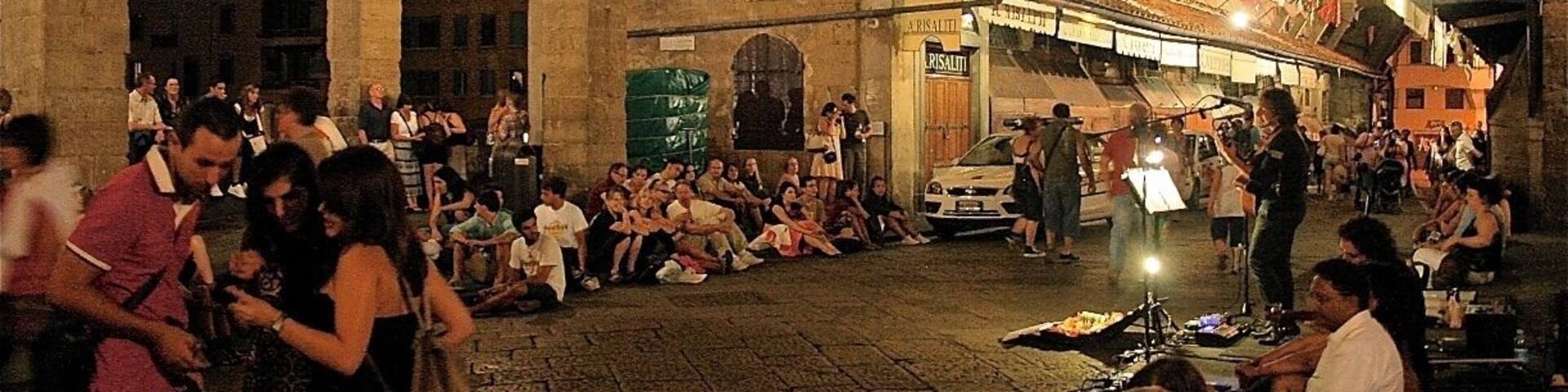Taken at night while troving around Florence. I decided to chill like the rest of the crowd and sat listening to the musician playing the guitar and singing. He did a good job at entertaining us.