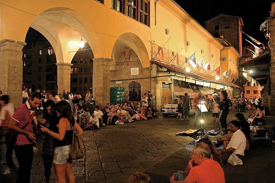 Taken at night while troving around Florence. I decided to chill like the rest of the crowd and sat listening to the musician playing the guitar and singing. He did a good job at entertaining us.