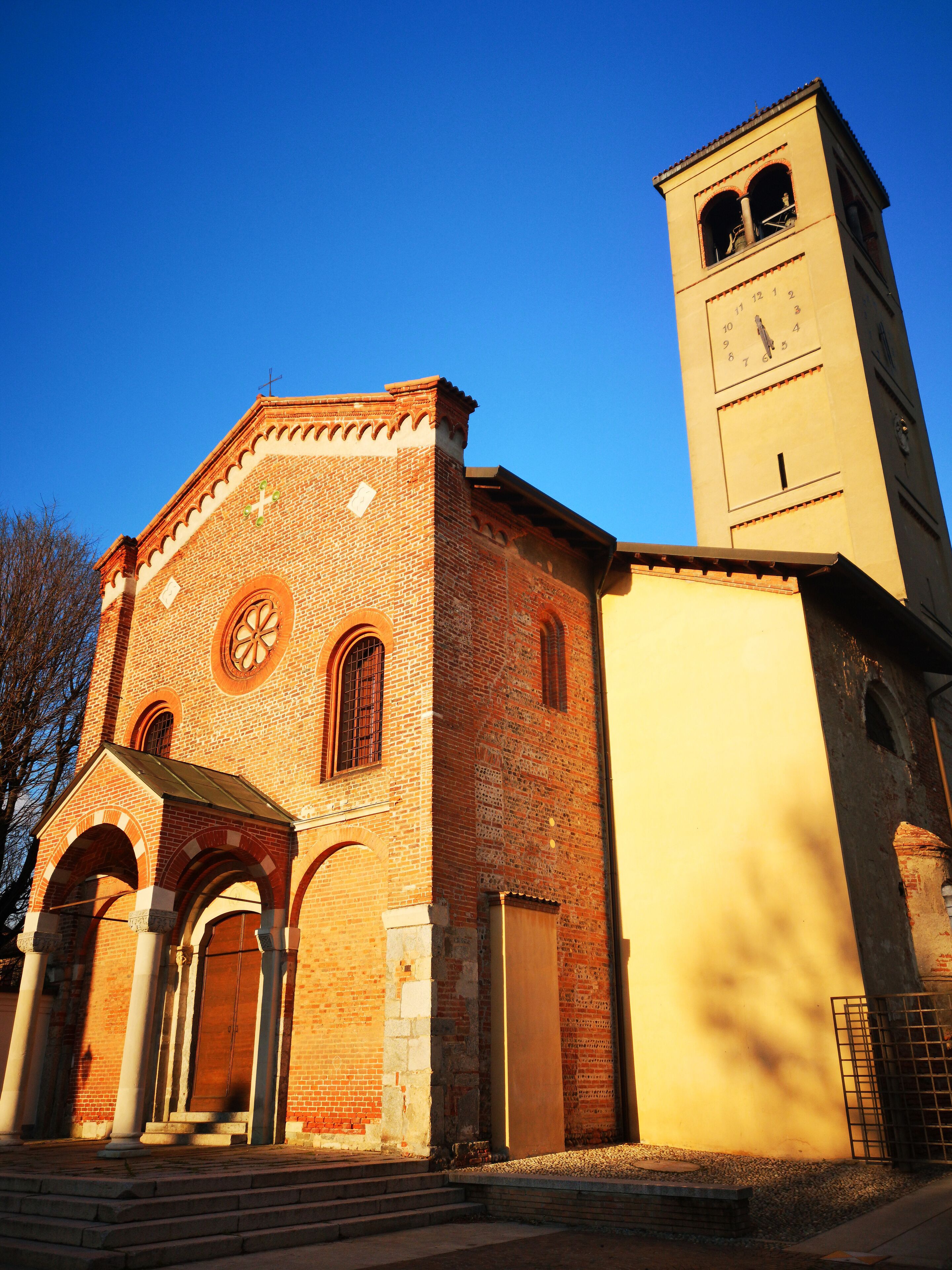 A church with a clock tower and a brick facade.