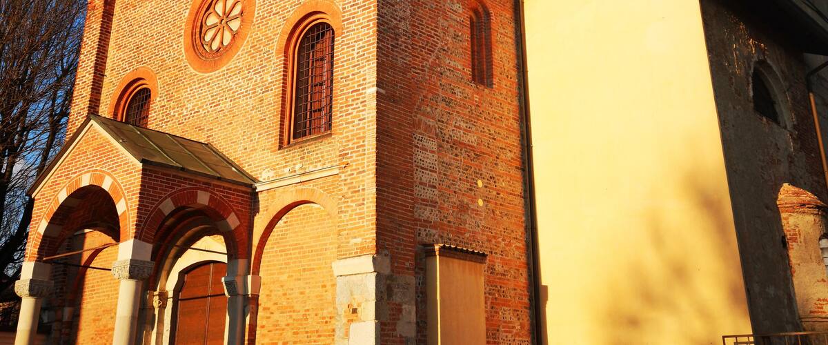A church with a clock tower and a brick facade.