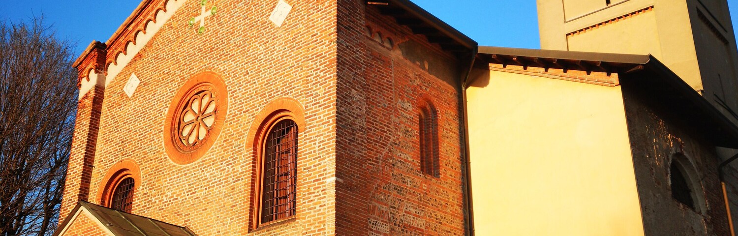 A church with a clock tower and a brick facade.