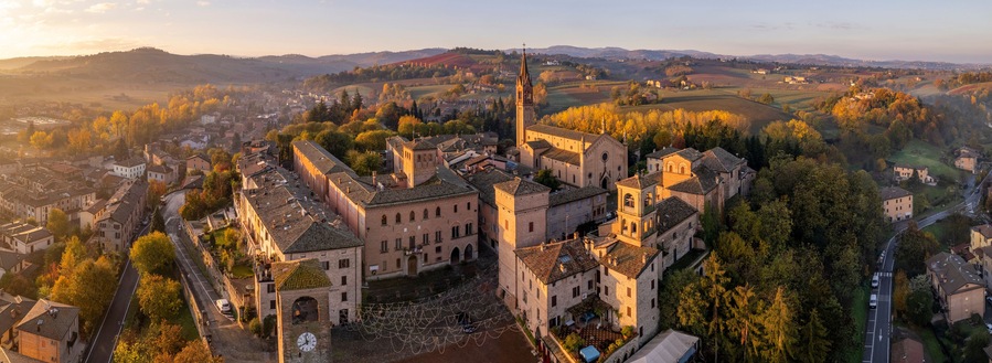 Lovevy aerial panoramic view of Castelvetro di Modena at sunrise among vineyards on Fall season