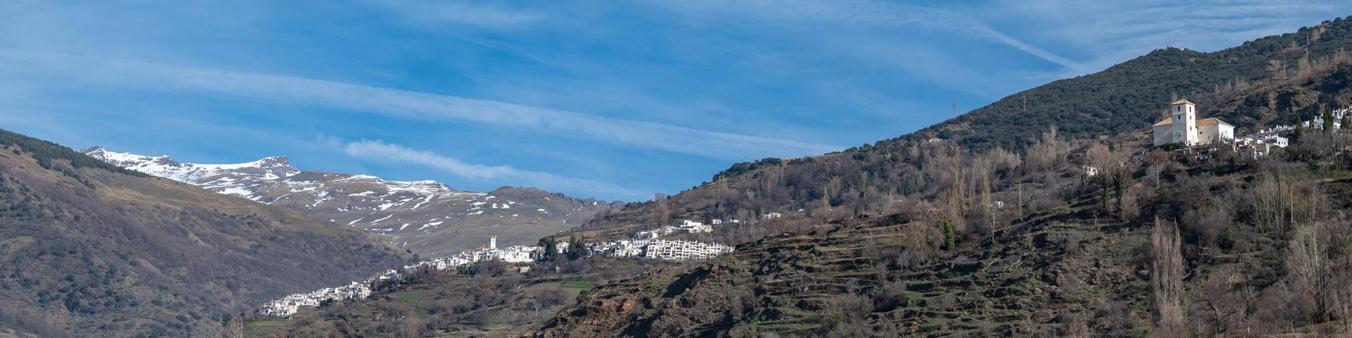 Panoramic view of the picturesque Granada village of Capileira (1436 m altitude) and Bubion in the Alpujarra on a sunny winter morning