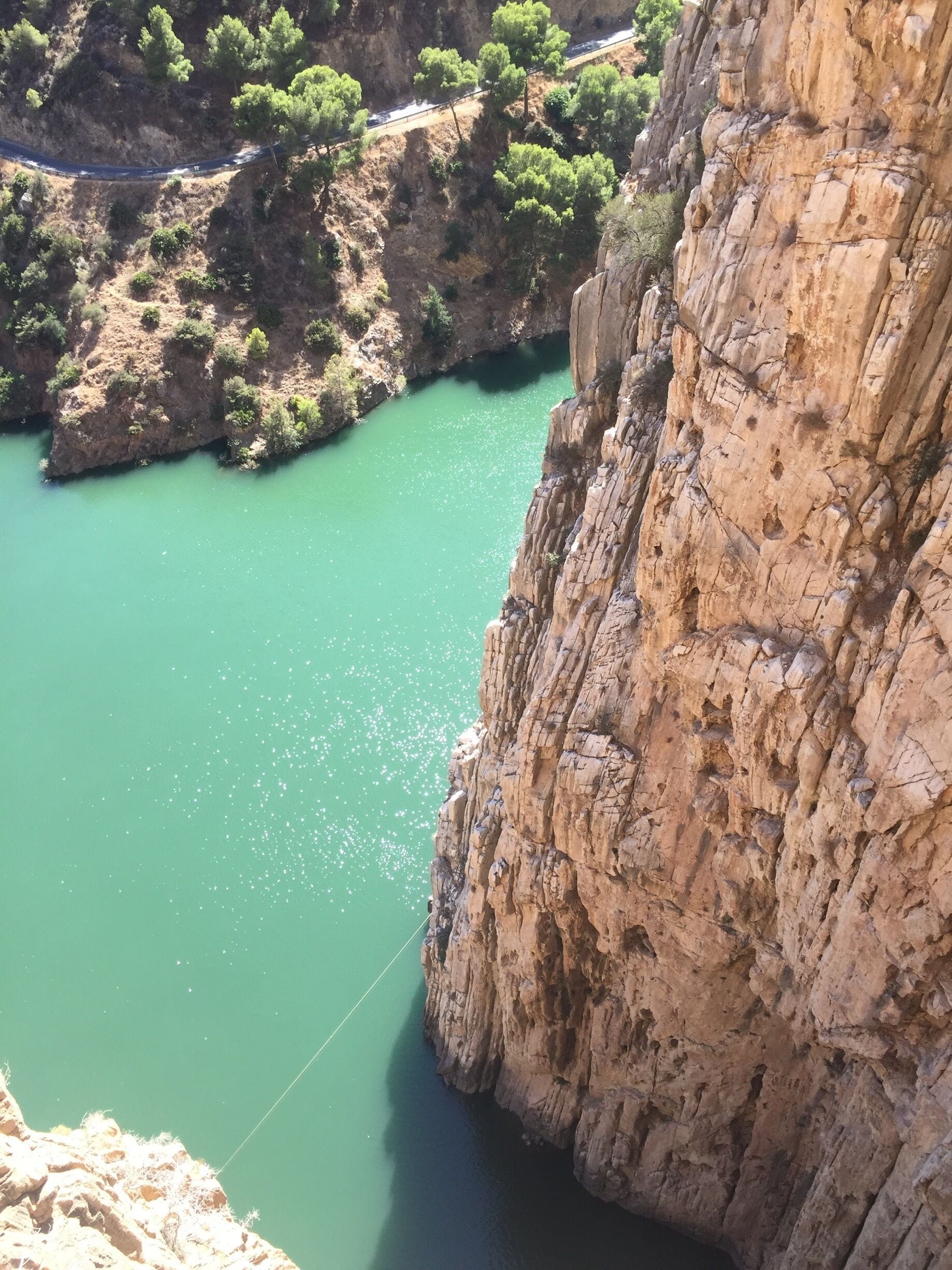 El Caminito del Rey is a very beautiful walkway, pinned along the steep walls of a narrow gorge in El Chorro, Spain. 
If you are visiting Malaga, it is easily accessible with a renfe train which takes about 40 minutes.