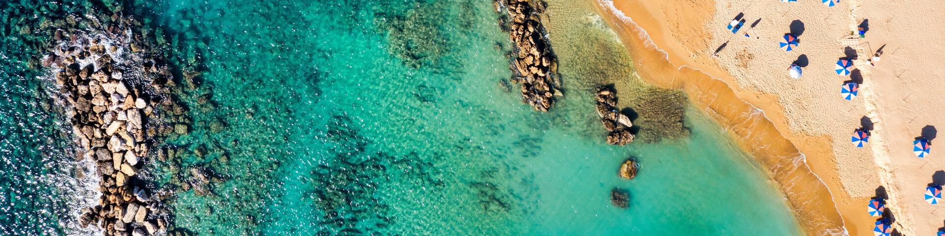 Aerial panoramic view of Coral bay beach, Cyprus. Overhead view of Coral Bay beach, Peyia village, Paphos district, Cyprus. Aerial view of Coral Bay beach in Peyia village, Cyprus.