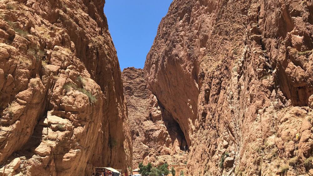 A canyon with steep rock walls and a clear blue sky.