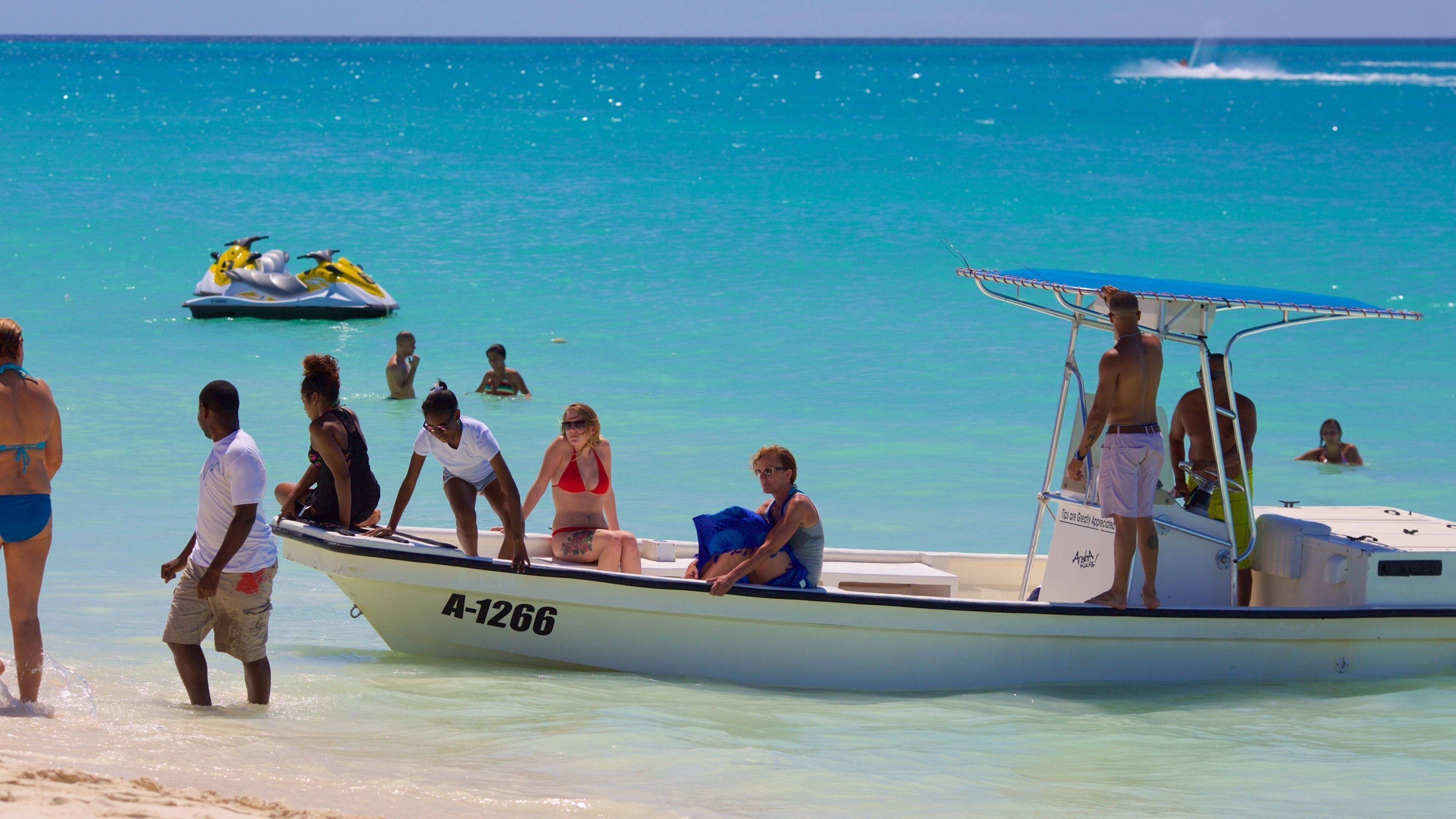 Eagle Beach featuring general coastal views as well as a small group of people