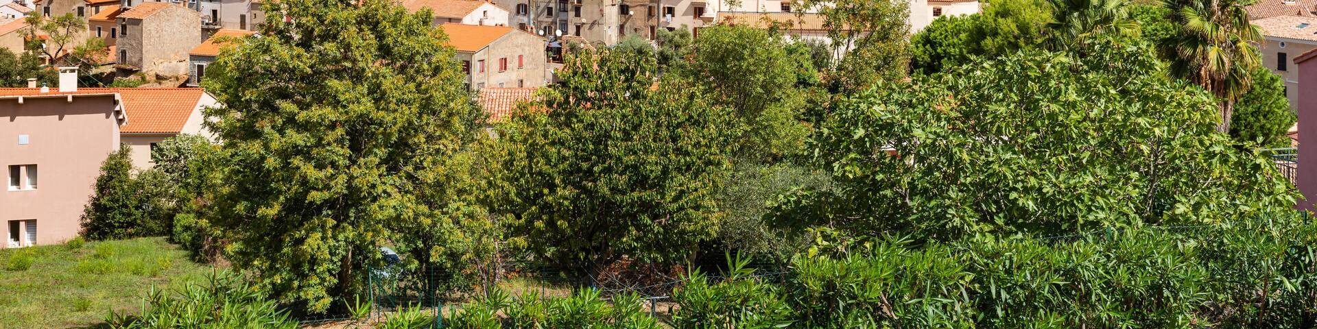 View of Piana village with church tower in mountain landscape of western Corsica, France