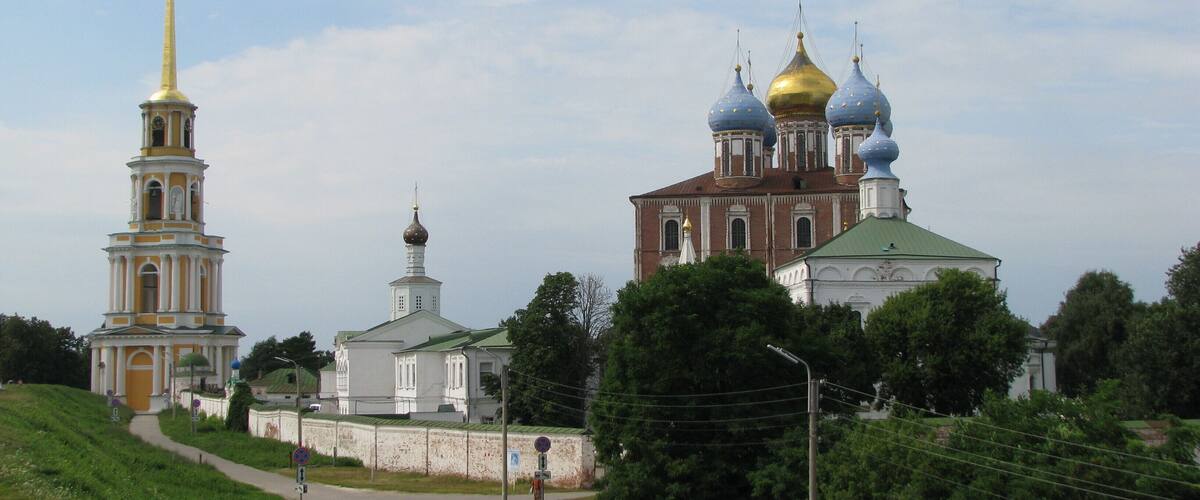 A church with golden domes and a tall bell tower.