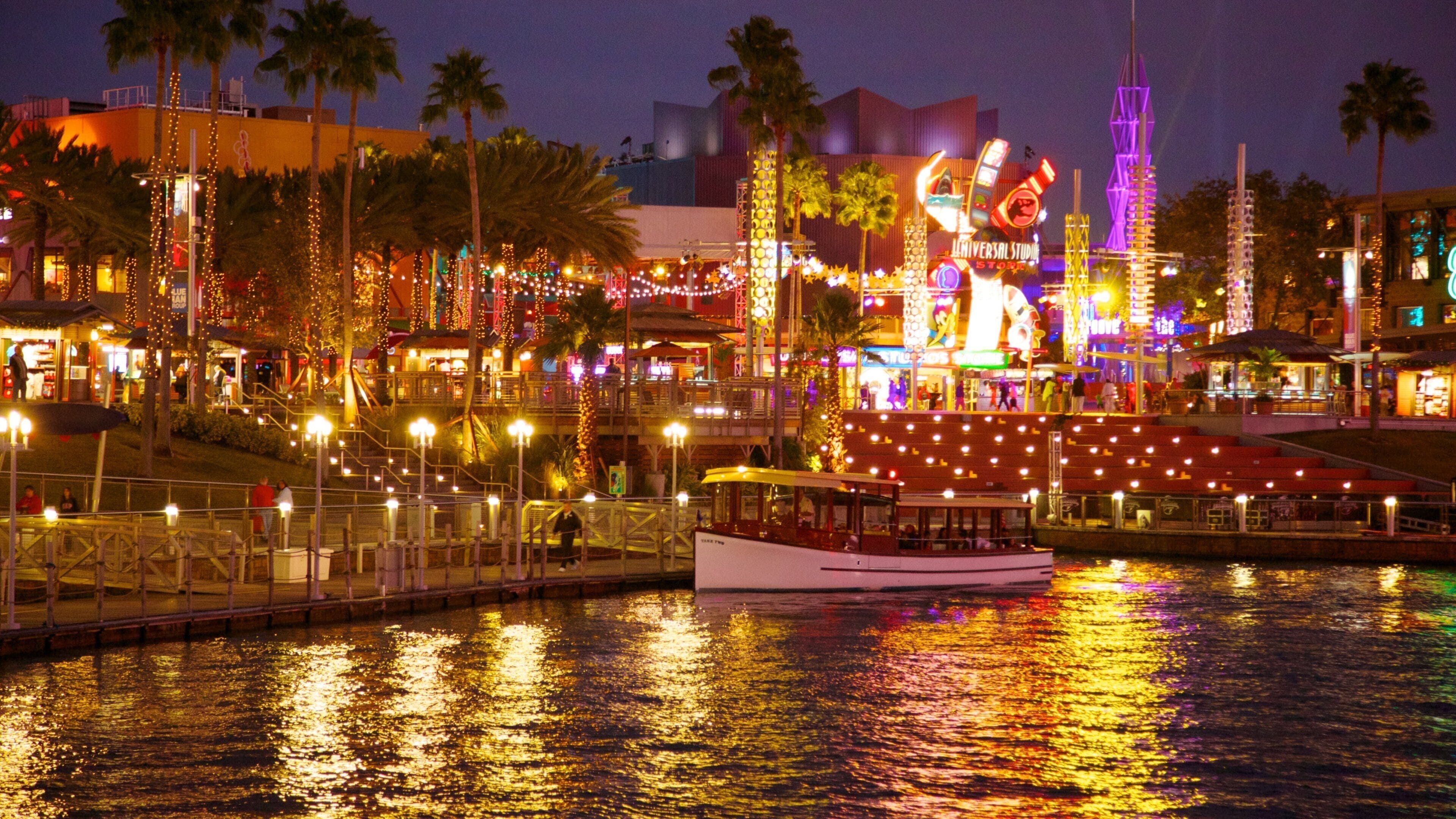 Vibrant night view of Universal Studios Florida showcasing lights and attractions by the water